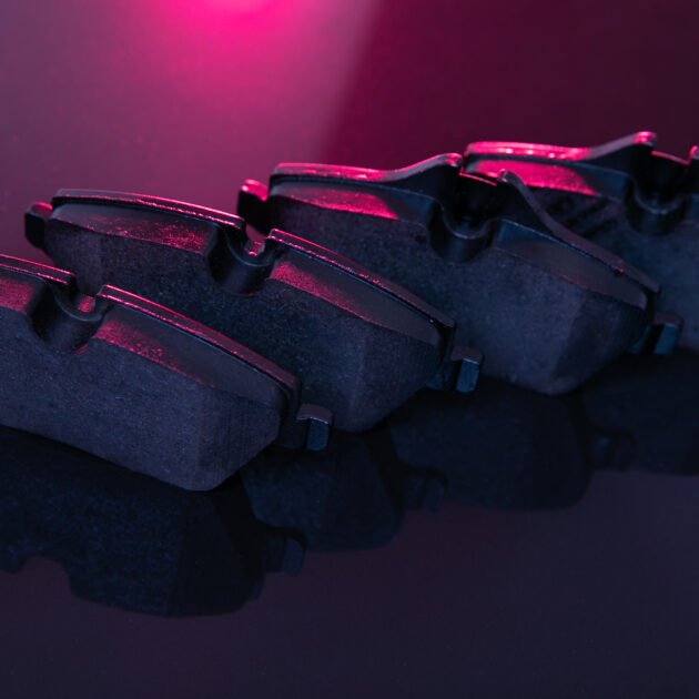 car brake system element, brake pads, close-up, artistic lighting