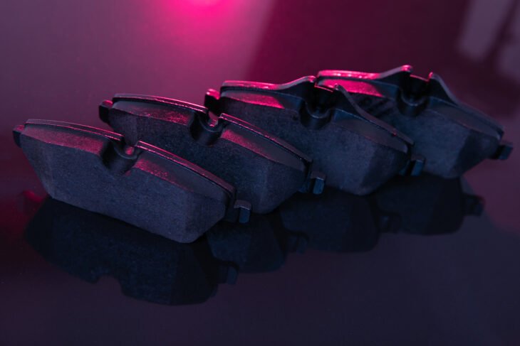 car brake system element, brake pads, close-up, artistic lighting