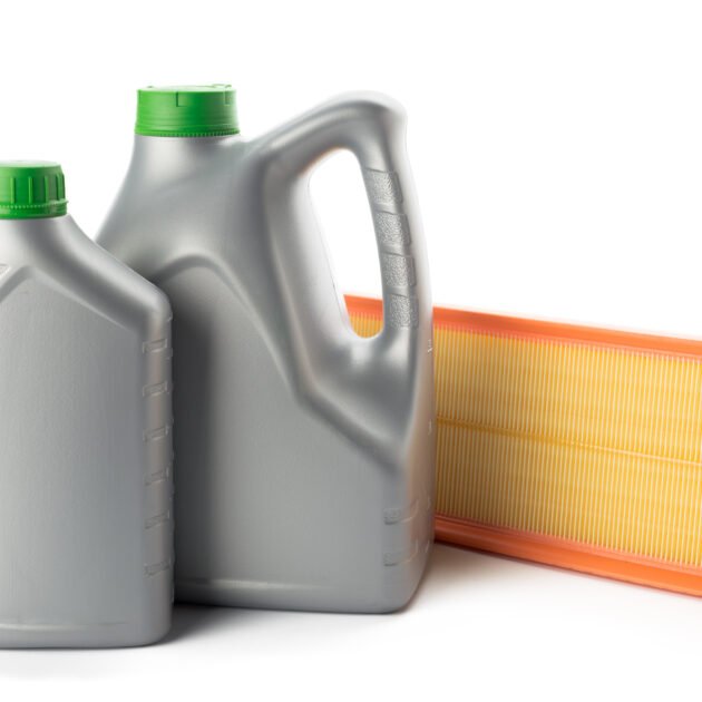 Car oil filters and motor oil can isolated on white