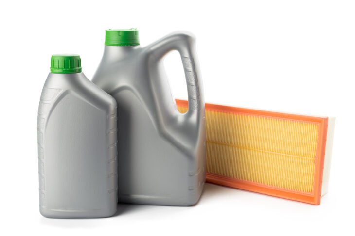 Car oil filters and motor oil can isolated on white